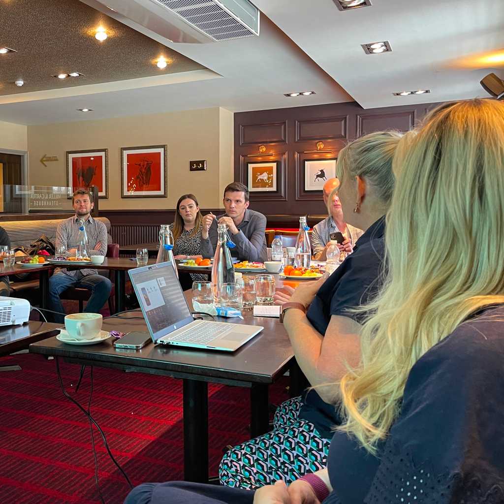 A photograph of a social media strategy workshop in progress. People are sitting around dinner tables in a Miller and Carter restaurant. Two people are leading the session, Maxine Catley and Emmaline McAndrew from Brew Digital, the specialist hospitality marketing agency in Birmingham.