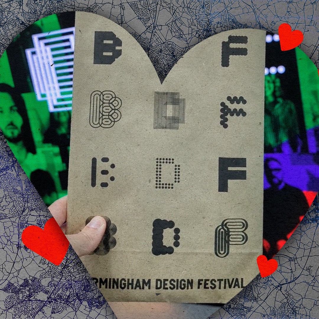 A hand holding a goody bag from the Birmingham Design Festival.