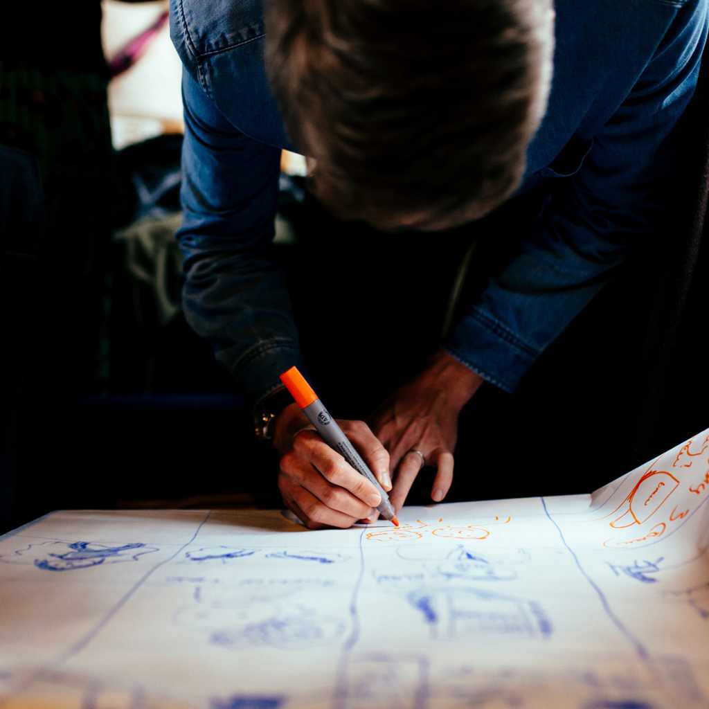 Brew’s lead designer, Scott, scribbling away on a sheet of paper at a brand identity workshop. 